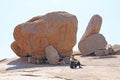 Bald Man in Hampi. A man is sitting on a background of large stones in Hampi. Man is a tourist.