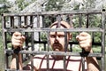 Bald man in jail or prison. Men in cage outdoor. danger or aggression conceptbald man Royalty Free Stock Photo