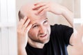 Bald man looking mirror at head baldness and hair loss Royalty Free Stock Photo