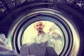 Bald man with mustache is bringing clothes or fabric in to the w Royalty Free Stock Photo