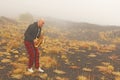 A bald man plays on a gold alto saxophone in the nature, against Royalty Free Stock Photo