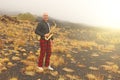 A bald man plays on a gold alto saxophone in the nature, against Royalty Free Stock Photo