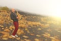 A bald man plays on a gold alto saxophone in the nature, against Royalty Free Stock Photo