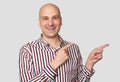 Bald man pointing to copy space. Isolated Royalty Free Stock Photo