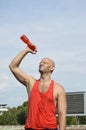 bald man pouring water over his head after outdoor sports training Royalty Free Stock Photo