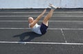 bald man pumps the press on the rubber surface of the city stadium Royalty Free Stock Photo