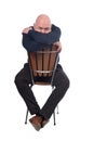 Bald man sitting on white background, cover his face with his arms Royalty Free Stock Photo