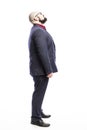 A bald man in a suit looks up. Side view. Full height. on a white background.