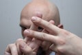 Bald man in a suit shows fingers. Lattice sign, hashtag, musical sharp Royalty Free Stock Photo