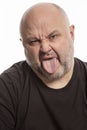 Bald man with tongue hanging out, close-up Royalty Free Stock Photo