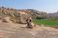 Bald Man is a tourist and photographer in Hampi. Large stones Hampi on the side of the village of Anegundi and Virupapur Gaddi.