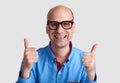 Bald man wearing cpectacles showing thumbs up Royalty Free Stock Photo