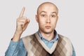 Bald serious man points and threatens with forefinger Royalty Free Stock Photo