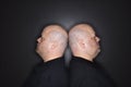 Bald twin men back to back. Royalty Free Stock Photo