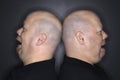 Bald twin men back to back. Royalty Free Stock Photo