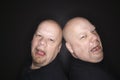 Bald twin men crying. Royalty Free Stock Photo