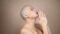 Bald woman folding her hands in prayer. beige background Royalty Free Stock Photo