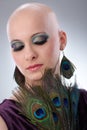 Bald woman with peacock plumes Royalty Free Stock Photo