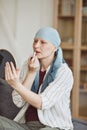 Bald Woman Putting On Lipstick