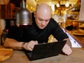 Bald young man looking at laptop Royalty Free Stock Photo