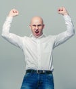 Bald young man portrait success hands up