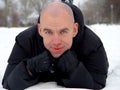 Bald young man on the snow