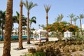 Baldachin white canopy on pillars above the bed and palm trees on a tropical warm sea resort, rest