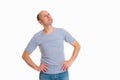 Baldheaded man in front of white background looking sidewards