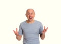 Baldheaded man with open hands looking surprised