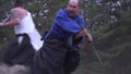 The balding samurai avoids from the hits of a heavy halberd