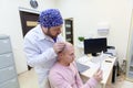 Baldness treatment. Patient suffering from hair loss in consultation with a doctor. Preparation for hair transplant Royalty Free Stock Photo