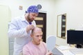 Baldness treatment. Patient suffering from hair loss in consultation with a doctor. Preparation for hair transplant Royalty Free Stock Photo