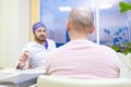 Baldness treatment. Patient suffering from hair loss in consultation with a doctor. Preparation for hair transplant Royalty Free Stock Photo