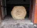 Bale of hay in the open stable gate, hayroll