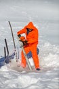 BALEA, ROMANIA - JANUARY 27 2017 - Worker cutting ice from the frozen lake for building the ice hotel at Balea Lake in the Fagaras