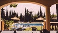 Balearic Villa in Mallorca Ibiza with a pool and sunloungers in lounge and palms and sunshade parasols Royalty Free Stock Photo