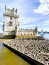 Balem Tower, historic fortification landmark near Lisbon, Portugal with sailboats in the background