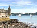 Balem Tower, historic fortification landmark near Lisbon, Portugal with sailboats in the background