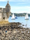 Balem Tower, historic fortification landmark near Lisbon, Portugal with sailboats in the background