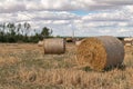 Bales of dry straw next to fields of corn Royalty Free Stock Photo