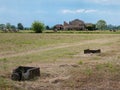 Bales of Hay in the Countryside and a Ruined Farmhouse