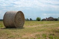 Bales of Hay in the Countryside and a Ruined Farmhouse in the background