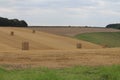 Square Bales field waiting to be harvested on a summers day in the UK Royalty Free Stock Photo
