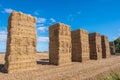 Hay bales stacked high in a line Royalty Free Stock Photo