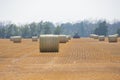 Bales of straw are being harvested by tractor Royalty Free Stock Photo