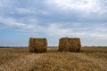 Bales of straw in a newly harvested field. Blue sky cloudy sky. Picture from Scania in Southern Sweden Royalty Free Stock Photo