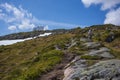 Hikers climb to the summit of Raudmelen peak which overlookis the town of Balestrand on Sognefjord during a summer morning