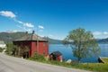 Traditional red painted Norwegian house with Sognefjord at the background in Balestrand, Norway. Royalty Free Stock Photo