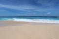 Bali beach with whate sand and blue waves Royalty Free Stock Photo