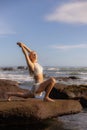 Bali beach yoga. Slim woman practicing Ashwa Sanchalanasana, Equestrian Pose. Fit body. Healthy lifestyle. Self-care concept. Copy Royalty Free Stock Photo